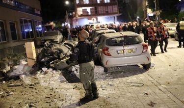 Police and first responders work at a scene where an apartment was damaged by a missile strike, in the outskirts of Tel Aviv, Israel on March 18, 2026. (Photo by Ilia YEFIMOVICH / AFP) /