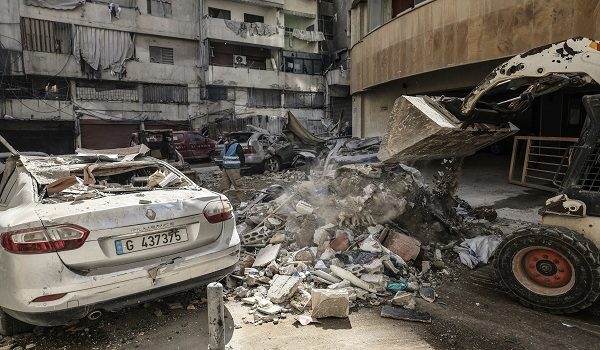 Workers clear debris from a street after an Israeli airstrike in central Beirut's Zuqaq al-Blat neighbourhood on March 18, 2026. Lebanon was drawn into the Middle East war on March 2 when Iran-backed militant group Hezbollah launched rockets towards Israel in response to US-Israeli strikes that killed Iranian supreme leader Ayatollah Ali Khamenei. (Photo by Anwar AMRO / AFP)
