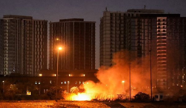 A fire burns outside the grounds of the US Embassy headquarters in Baghdad's fortified "Green Zone" on March 17, 2026 following a drone and rocket attack according to security officials. The strikes came hours after air defences thwarted a rocket attack at the embassy and a drone sparked a fire at a luxury hotel frequented by foreign diplomats in the Green Zone. Iraq was drawn into the Middle East war after having long been a proxy battleground between the US and Iran, with strikes targeting Iran-backed groups that have claimed daily attacks on US interests in Iraq and across the region. (Photo by AHMAD AL-RUBAYE / AFP) / The erroneous mention[s] appearing in the metadata of this photo by AHMAD AL-RUBAYE has been modified in AFP systems in the following manner: [outside the grounds] instead of [on the grounds]. Please immediately remove the erroneous mention[s] from all your online services and delete it (them) from your servers. If you have been authorized by AFP to distribute it (them) to third parties, please ensure that the same actions are carried out by them. Failure to promptly comply with these instructions will entail liability on your part for any continued or post notification usage. Therefore we thank you very much for all your attention and prompt action. We are sorry for the inconvenience this notification may cause and remain at your disposal for any further information you may require.