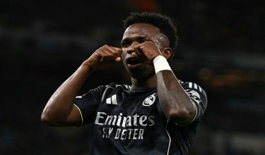Real Madrid's Brazilian forward #07 Vinicius Junior celebrates scoring the opening goal during the UEFA Champions League, round of 16 second leg football match between Manchester City and Real Madrid at the Etihad Stadium in Manchester, north west England, on March 17, 2026. (Photo by Paul ELLIS / AFP)
