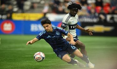 Apr 17, 2026; Vancouver, British Columbia, CAN;  Sporting Kansas City midfielder Manu Garcia (6) battles for the ball against Vancouver Whitecaps FC forward Emmanuel Sabbi (11) during the second half at BC Place. Mandatory Credit: Anne-Marie Sorvin-Imagn Images