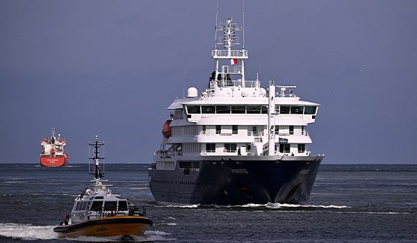 The Dutch Hantavirus-hit cruise ship MV Hondius sails off the Netherlands' coast as it approaches the port of Rotterdam on May 18, 2026. Cruise ship MV Hondius is expected to arrive at the port of Rotterdam and the ship's crew members will undergo a medical screening. (Photo by JOHN THYS / AFP)