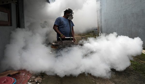 A worker from the Medical Officer of Health (MOH) department fumigates a residential area during a mosquito control programme in Colombo, Sri Lanka, June 19, 2026. REUTERS/Thilina Kaluthotage