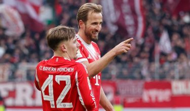 Bayern Munich's English forward #09 Harry Kane celebrates scoring the 0-2 goal with his teammate Bayern Munich's German midfielder #42 Lennart Karl during the German first division Bundesliga football match between SV Werder Bremen and FC Bayern Munich in Bremen, northern Germany February 14, 2026. (Photo by Focke Strangmann / AFP) / DFL REGULATIONS PROHIBIT ANY USE OF PHOTOGRAPHS AS IMAGE SEQUENCES AND/OR QUASI-VIDEO