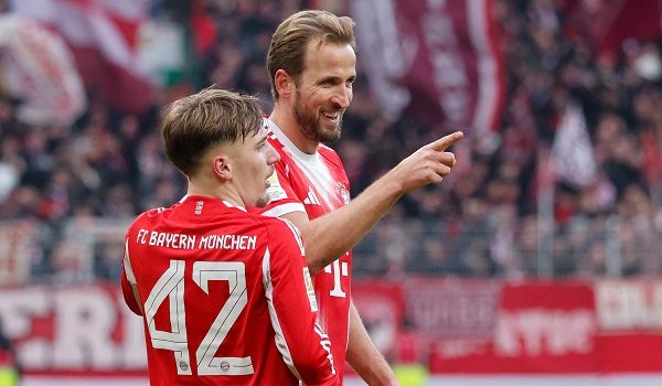 Bayern Munich's English forward #09 Harry Kane celebrates scoring the 0-2 goal with his teammate Bayern Munich's German midfielder #42 Lennart Karl during the German first division Bundesliga football match between SV Werder Bremen and FC Bayern Munich in Bremen, northern Germany February 14, 2026. (Photo by Focke Strangmann / AFP) / DFL REGULATIONS PROHIBIT ANY USE OF PHOTOGRAPHS AS IMAGE SEQUENCES AND/OR QUASI-VIDEO