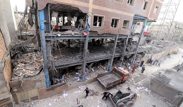 Iranian workers clear the debris from a damaged building, following a military strike on the Iranian capital Tehran on March 15, 2026. Iran's Foreign Minister said in an interview published on March 15, that the war pitting his country against the United States and Israel will only end when Tehran can be certain it will not be restarted. On February 28, Israel and the United States launched strikes on Iran, killing its supreme leader Ayatollah and triggering a war that spread across the Middle East. (Photo by Atta KENARE / AFP) /