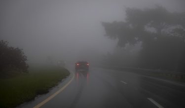 Sebuah kereta dipandu dalam keadaan kabus tebal di wilayah Cayey, Puerto Rico selepas Taufan Erin melemah ke Kategori 2/ Foto AFP