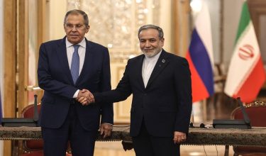 Russia's Foreign Minister Sergey Lavrov (L) and Iran's Foreign Minister Abbas Araghchi shake hands during a press conference after a meeting in Tehran on October 19, 2026. The Russian foreign minister arrived in Iran on October 19, in his first visit since the outbreak of the Middle East war as Moscow seeks to play a mediating role. (Photo by ATTA KENARE / AFP)