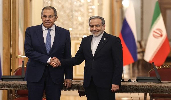 Russia's Foreign Minister Sergey Lavrov (L) and Iran's Foreign Minister Abbas Araghchi shake hands during a press conference after a meeting in Tehran on October 19, 2026. The Russian foreign minister arrived in Iran on October 19, in his first visit since the outbreak of the Middle East war as Moscow seeks to play a mediating role. (Photo by ATTA KENARE / AFP)