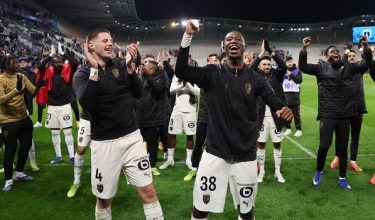 Lens' Bosnian defender #04 Nidal Celik (CL) and Lens' French forward #38 Rayan Fofana (CR) celebrate their team's victory at the end of the French L1 football match between Paris FC and RC Lens at the Stade Jean-Bouin in Paris on February 14, 2026. (Photo by ALAIN JOCARD / AFP)