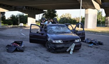 SENSITIVE MATERIAL. THIS IMAGE MAY OFFEND OR DISTURB. Police officers inspect a damaged car after they extracted from inside the bodies of two people killed by a Russian airstrike, amid Russia's attack on Ukraine, in Zaporizhzhia, Ukraine, June 20, 2026. REUTERS/Stringer