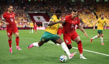 VANCOUVER, BRITISH COLUMBIA - JUNE 13: Mohamed Toure #9 of Australia crosses the ball under pressure of Abdulkerim Bardakci #14 of Turkiye during the FIFA World Cup 2026 Group D match between Australia and Türkiye at BC Place Vancouver on June 13, 2026 in Vancouver, British Columbia.   Stu Forster/Getty Images/AFP (Photo by Stu Forster / GETTY IMAGES NORTH AMERICA / Getty Images via AFP)