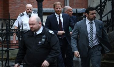 (FILES) Britain's Prince Harry, Duke of Sussex (C), leaves the Royal Courts of Justice, Britain's High Court, in London on January 22, 2026, on the fourth day of the trial in his case against a major UK newspaper group. Prince Harry and others are ordered to pay Daily Mail £9.5-mln in initial costs, August 21. (Photo by Henry NICHOLLS / AFP)