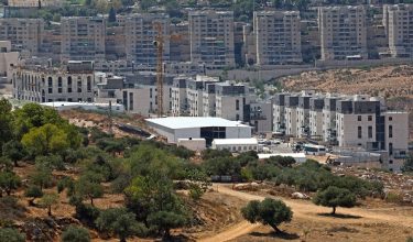 This photograph taken from the outskirts of the east Jerusalem neighbourhood of Beit Hanina, shows a construction crane at Ramat Shlomo, a Jewish settlement in the Israeli-annexed eastern sector of Jerusalem on August 18, 2026. (Photo by AHMAD GHARABLI / AFP)