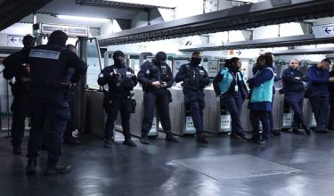 RATP transport security officers and RATP staff stand inside the closed off Republique Metro station during a partial curfew for parts of the capital, in Paris on October 20, 2026, after weekend demonstrations over soaring prices degenerated into some of the worst street violence in recent years. Paris police ordered a new curfew for parts of the city for October 20, after a curfew on the previous night that authorities said resulted in calm being restored following weekend riots and looting. The fresh curfew runs from 2100 GMT on October 20, 2026 to 0400 GMT October 21, 2026 and applies to the Republique public square in the city's central east, where many weekend clashes took place, and in the central les Halles district which is full of shops as well as nearby train stations. (Photo by SIMON WOHLFAHRT / AFP)