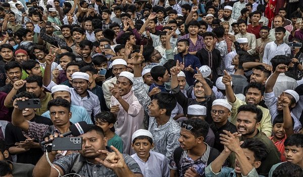 People shout slogans during a protest over alleged child rape in Dhaka on May 22, 2026. Thousands of protesters in Bangladesh clashed with police in a bid to seize a suspect accused of raping a four-year-old girl, officials said on May 22. (Photo by Abdul Goni / AFP)
