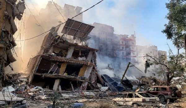 Smoke rises by destroyed buildings from the site of an Israeli air strike the previous day on the neighbourhood of Mreijeh in Beirut's southern suburbs on October 23, 2024. Israel expanded operations in Lebanon nearly a year after Hezbollah began exchanging fire in support of its ally, Hamas, following the Palestinian group's deadly attack on Israel on October 7, 2023. (Photo by AFP)