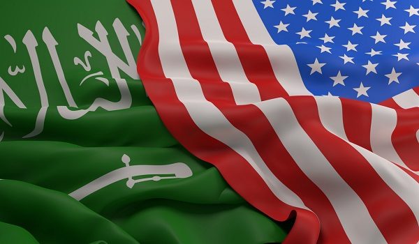 Flag of the USA laying over the flag of Saudi Arabia