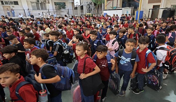 Children gather upon their arrival on the first day of the start of their school year at the Latin Patriarchate School built inside the premises of the Holy Family Church in the Zeitoun neighborhood of Gaza City on September 22, 2026. (Photo by Omar AL-QATTAA / AFP)