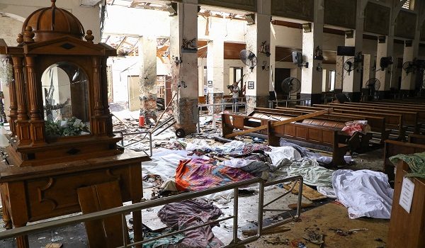 EDITORS NOTE: Graphic content / (FILES) Sri Lankan security personnel walk past dead bodies covered with blankets amid blast debris at St. Anthony's Shrine following an explosion in the church in Kochchikade in Colombo on April 21, 2019. Sri Lanka is set to conclude on September 22 the trial of 24 men accused of plotting the 2019 Easter Sunday bombings, the deadliest attack against civilians in the island's history. (Photo by ISHARA S. KODIKARA / AFP)