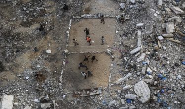 Palestinian children play volleyball on a makeshift court made of rubble in Gaza City on September 15, 2026. Israel's full-scale war on Gaza -- which began after a Hamas attack inside Israel on October 7, 2023 -- reduced much of the Palestinian territory to rubble. The relentless Israeli bombardment and ground offensive has killed more than 73,000 Palestinians, including more than 1,350 since a ceasefire agreed last October, according to Gaza's health ministry, which is under Hamas authority. (Photo by Omar AL-QATTAA / AFP)