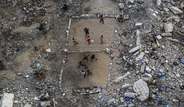 Palestinian children play volleyball on a makeshift court made of rubble in Gaza City on September 15, 2026. Israel's full-scale war on Gaza -- which began after a Hamas attack inside Israel on October 7, 2023 -- reduced much of the Palestinian territory to rubble. The relentless Israeli bombardment and ground offensive has killed more than 73,000 Palestinians, including more than 1,350 since a ceasefire agreed last October, according to Gaza's health ministry, which is under Hamas authority. (Photo by Omar AL-QATTAA / AFP)