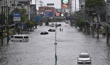 Vehicles are seen stranded in flood waters along Phetchaburi Road in Bangkok on September 26, 2026. Bangkok authorities declared on September 26 a disaster across all 50 districts of the Thai capital after continuous rain caused heavy flooding. (Photo by Lillian SUWANRUMPHA / AFP)