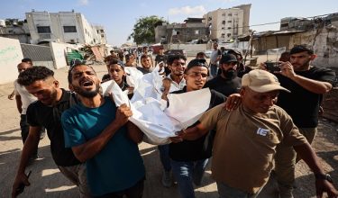 Mourners carry the body of one of three Palestinians during their funeral at Al Shifa Hospital in Gaza City on October 25, 2026, after they were killed in an Israeli strike on the Islamic University building. An Israeli strike on a university in Gaza City killed three people on October 25, staff and a local hospital said, while the civil defence agency reported four others killed elsewhere in the territory. Reached for comment, the Israeli military said it was looking into the reports. (Photo by Omar AL-QATTAA / AFP)