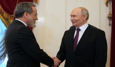 Russian President Vladimir Putin shakes hands with Iranian Foreign Minister Abbas Araghchi during their meeting at the Boris Yeltsin Presidential Library in Saint Petersburg on April 27, 2026. (Photo by Dmitry LOVETSKY / POOL / AFP)