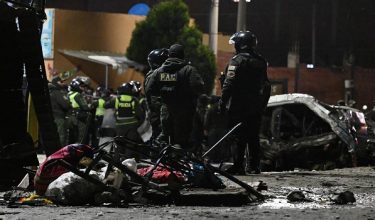 Emergency personnel gather at the site where a Bolivian Air Force Hercules aircraft crashed on Friday evening onto a busy avenue amid inclement weather in the city of El Alto, Bolivia, February 27, 2026. REUTERS/Claudia Morales