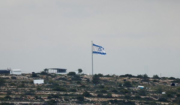 An Israeli flag flutters at a new Israeli settlement near Ramallah, in the Israeli-occupied West Bank, April 11, 2026. REUTERS/Mohammed Torokman