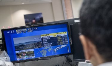 Reporters watch the news showing a large quake and possible one meter tsunami wave in Southern Japan, from an office in Tokyo on July 28, 2026. A strong 7.1-magnitude earthquake hit southern Japan, the Japan Meteorological Agency said, issuing a tsunami alert. The tremor also measured at the highest possible level seven on Japan's own Shindo scale of shaking, the agency said. (Photo by Andrew CABALLERO-REYNOLDS / AFP)