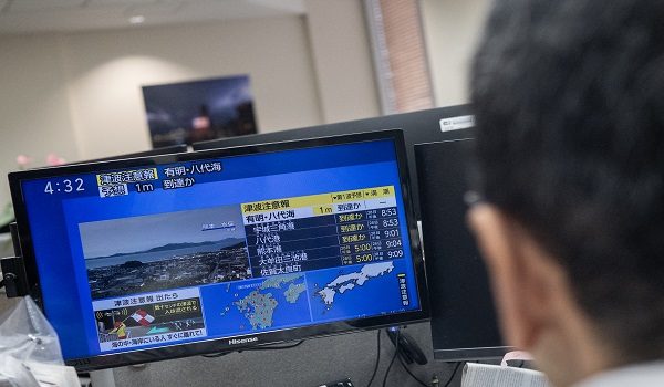 Reporters watch the news showing a large quake and possible one meter tsunami wave in Southern Japan, from an office in Tokyo on July 28, 2026. A strong 7.1-magnitude earthquake hit southern Japan, the Japan Meteorological Agency said, issuing a tsunami alert. The tremor also measured at the highest possible level seven on Japan's own Shindo scale of shaking, the agency said. (Photo by Andrew CABALLERO-REYNOLDS / AFP)