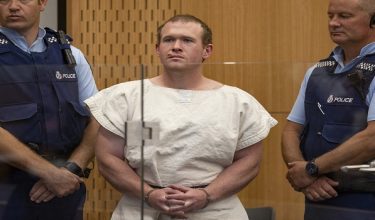 (FILES) In this picture taken on March 16, 2019, Brenton Tarrant (C), the man charged in relation to the Christchurch massacre, stands in the dock during his appearance at the Christchurch District Court. White supremacist killer Brenton Tarrant lost his appeal on April 30, 2026, seeking to overturn his conviction and sentence for shooting dead 51 people at two New Zealand mosques in 2019. (Photo by MARK MITCHELL / Wellington Court of Appeal / AFP) / RESTRICTED TO EDITORIAL USE - MANDATORY CREDIT "AFP PHOTO / WELLINGTON COURT OF APPEAL" - HANDOUT - NO MARKETING NO ADVERTISING CAMPAIGNS - DISTRIBUTED AS A SERVICE TO CLIENTS