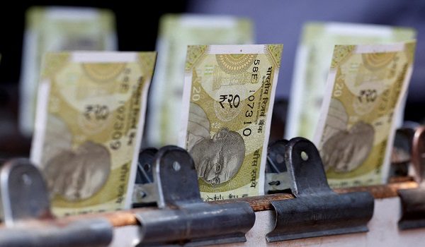 FILE PHOTO: Indian twenty rupee currency notes are displayed at a roadside currency exchange stall in New Delhi, India, May 24, 2024. REUTERS/Priyanshu Singh/File Photo