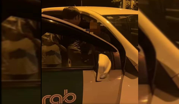 Tangkap layar video tular menunjukkan pemandu e-hailing ditahan keluarga cuba melakukan gangguan seksual