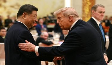 China's President Xi Jinping (L) looks at US President Donald Trump as they attend a state banquet at the Great Hall of the People in Beijing on May 14, 2026. (Photo by Brendan SMIALOWSKI / AFP)
