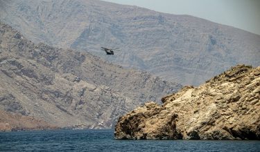 An Omani NH90 military helicopter patrols in the Strait of Hormuz off Khasab in Omans northern Musandam peninsula on June 25, 2025. (Photo by Giuseppe CACACE / AFP)
