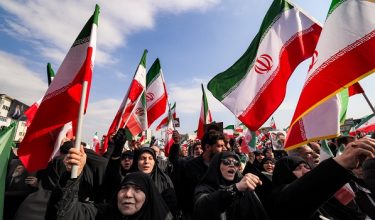 Demonstrators gather with Iranian national flags for a rally in support of the new Supreme Leader at Enghelab Square in central Tehran on March 9, 2026. Iran marked the appointment of Ayatollah Mojtaba Khamenei to replace his father as its supreme leader with a new barrage of missiles against Israel and the Gulf states on Monday, as the Middle East war sent oil prices soaring. (Photo by ATTA KENARE / AFP)