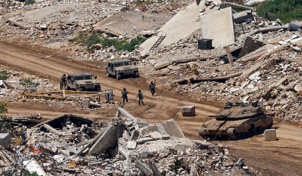 This photograph taken from the northern Israel shows Israeli tanks and military vehicles standing along the road between destroyed houses in southern Lebanon near the border with Israel, on April 29, 2026. Lebanon's army said on April 29 that one of its soldiers was among two people killed in an Israeli strike in the country's south, the latest deadly raid despite a ceasefire in the Israel-Hezbollah war. (Photo by Jalaa MAREY / AFP)