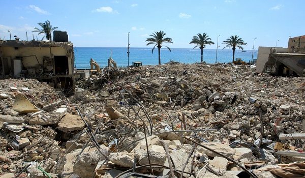 This picture shows the rubble of buildings destroyed in Israeli strikes in the southern Lebanese coastal city of Tyre on April 21, 2026. Israeli defence minister said on April 21 that his country's campaign in Lebanon relied on both military and diplomatic pressure to disarm Iran-allied Hezbollah. Though a truce between Israel and Lebanon took effect on April 17, Israeli troops are still present and actively fighting Hezbollah militants in Lebanon's south. (Photo by Mahmoud ZAYYAT / AFP)