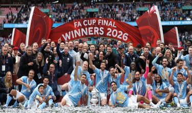 Manchester City's players and staff celebrate with the trophy on the pitch after the English FA Cup final football match between Chelsea and Manchester City at Wembley stadium in London, on May 16, 2026. Manchester City won the game 1-0. The third FA Cup success of Guardiola's reign ended City's run of two successive defeats in the final. (Photo by Adrian Dennis / AFP) / NOT FOR MARKETING OR ADVERTISING USE / RESTRICTED TO EDITORIAL USE