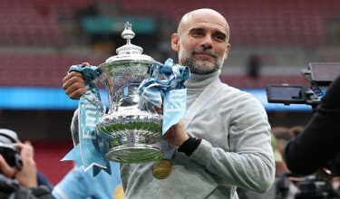(FILES) Manchester City's Spanish manager Pep Guardiola poses with the trophy on the pitch after the English FA Cup final football match between Chelsea and Manchester City at Wembley stadium in London, on May 16, 2026. Pep Guardiola is set to bring his trophy-laden decade in charge of Manchester City to an end this weekend, according to multiple reports on Monday. Guardiola, 55, has won six Premier League titles and City's first Champions League among 20 trophies since arriving in England in 2016. (Photo by Adrian Dennis / AFP) / NOT FOR MARKETING OR ADVERTISING USE / RESTRICTED TO EDITORIAL USE