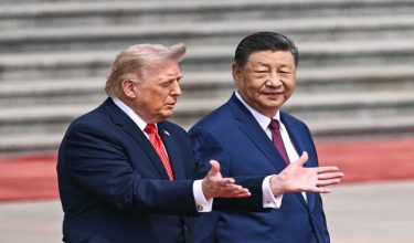 US President Donald Trump (L) takes part in a welcome ceremony with China's President Xi Jinping at the Great Hall of the People in Beijing on May 14, 2026. (Photo by Brendan SMIALOWSKI / AFP)