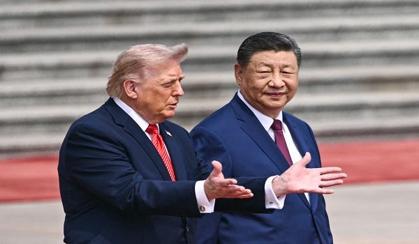 US President Donald Trump (L) takes part in a welcome ceremony with China's President Xi Jinping at the Great Hall of the People in Beijing on May 14, 2026. (Photo by Brendan SMIALOWSKI / AFP)